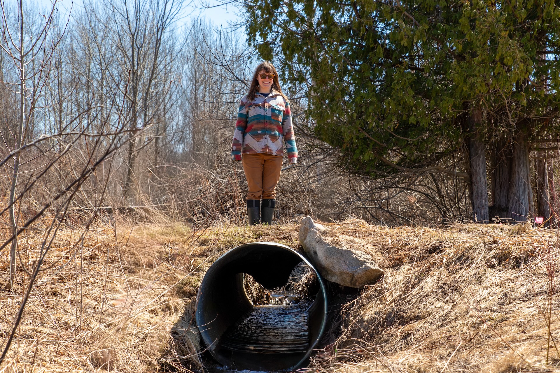 Conservation staff inspect an undersized stream culvert at Mitchell Creek Meadows Nature Preserve prior to restoration work.